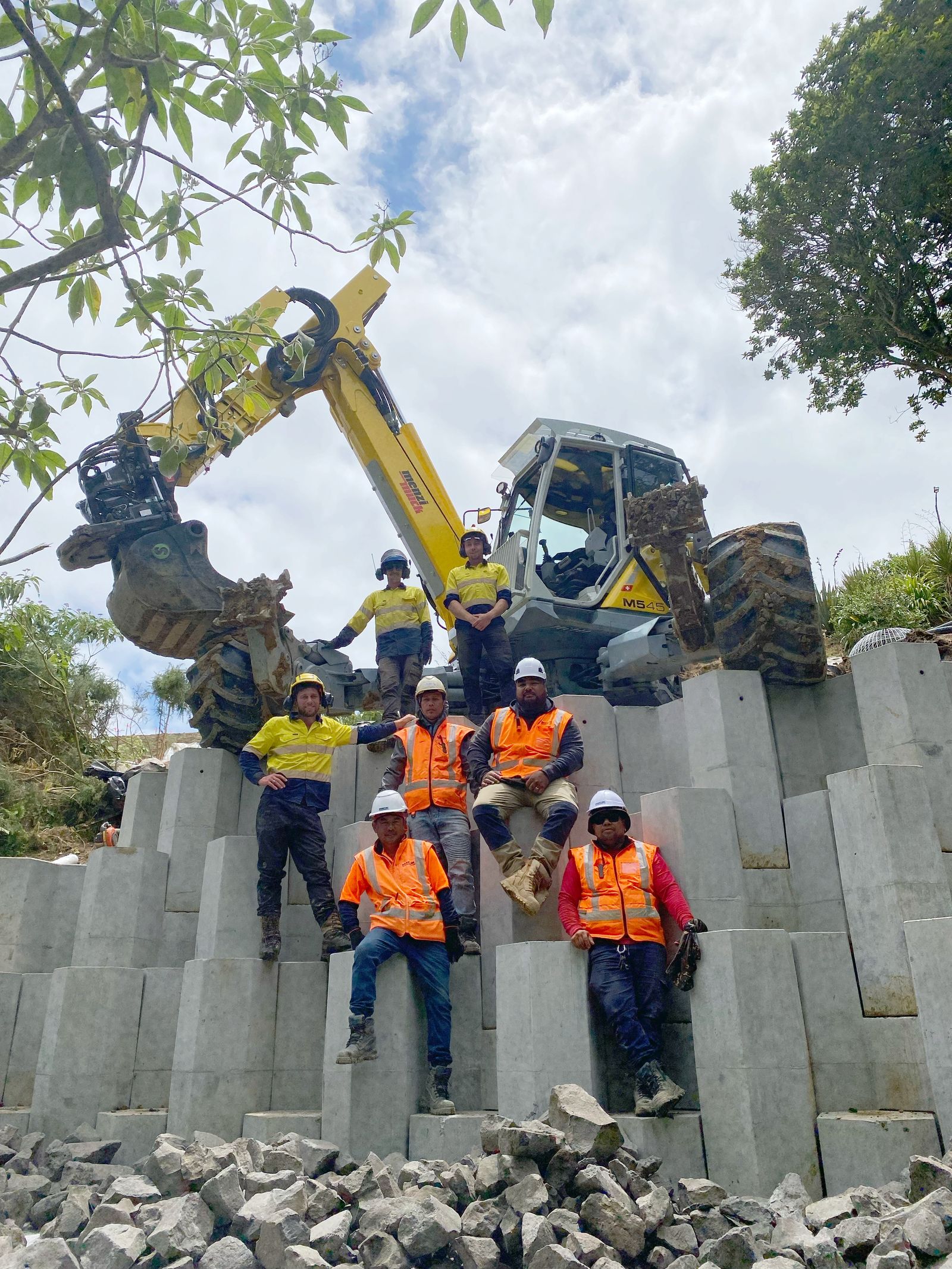 The Tough Terrain crew on site in front of a completed retaining wall
