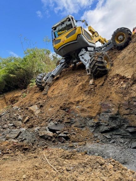 Menzi Muck perched on the 1:1 slope above McQuoids stream